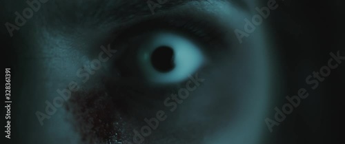 Terrifying creepy zombie woman, close up of white eye. Scary look. BMPCC 4K