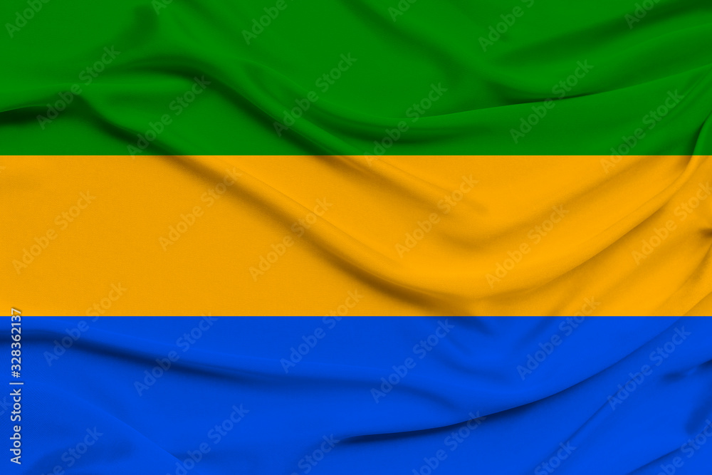 beautiful photo of the national flag of Gabon on delicate shiny silk with soft draperies, the concept of state power, country life, horizontal, close-up, copy space beautiful photo of the national flag of Gabon on delicate shiny silk with soft draperies, the concept of state power, country life, horizontal, close-up, copy space