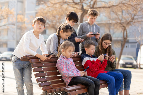 Children addicted in their phones outdoors