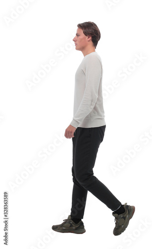 side view . modern young man stepping forward