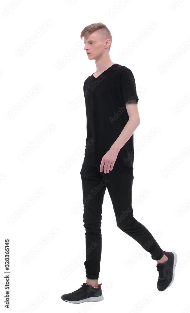 in full growth. modern guy student slowly goes forward in full growth. modern guy student slowly goes forward