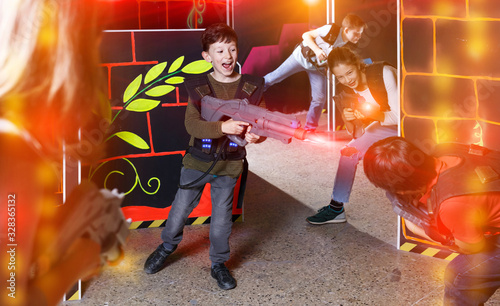 Jolly kids aiming laser guns at other players