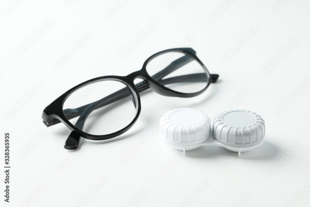 Gasses and contct lenses on white background, close up