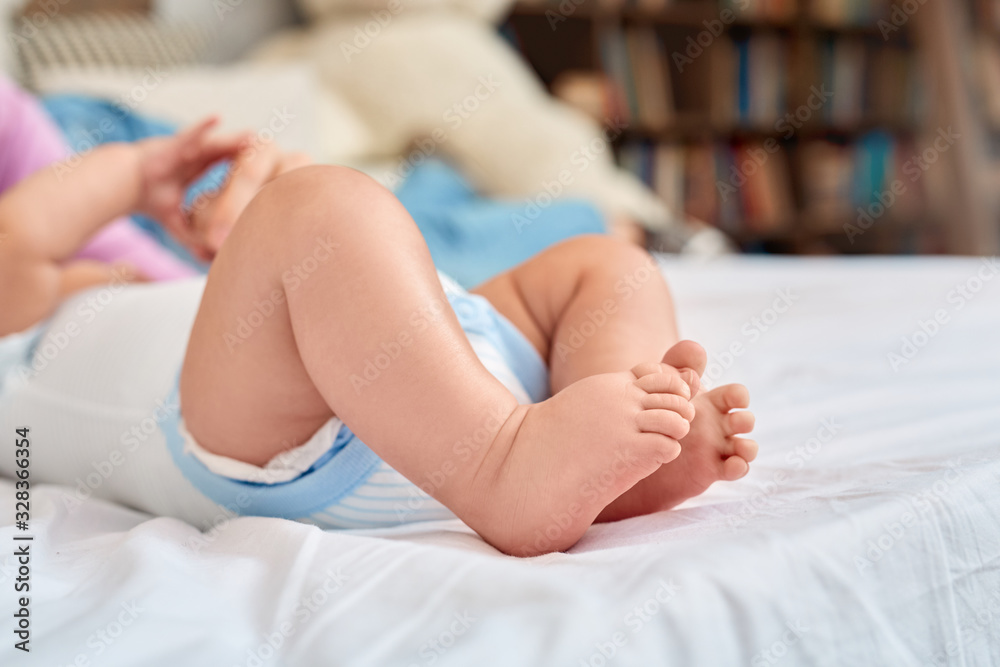 Tender and tiny feet of little newborn child