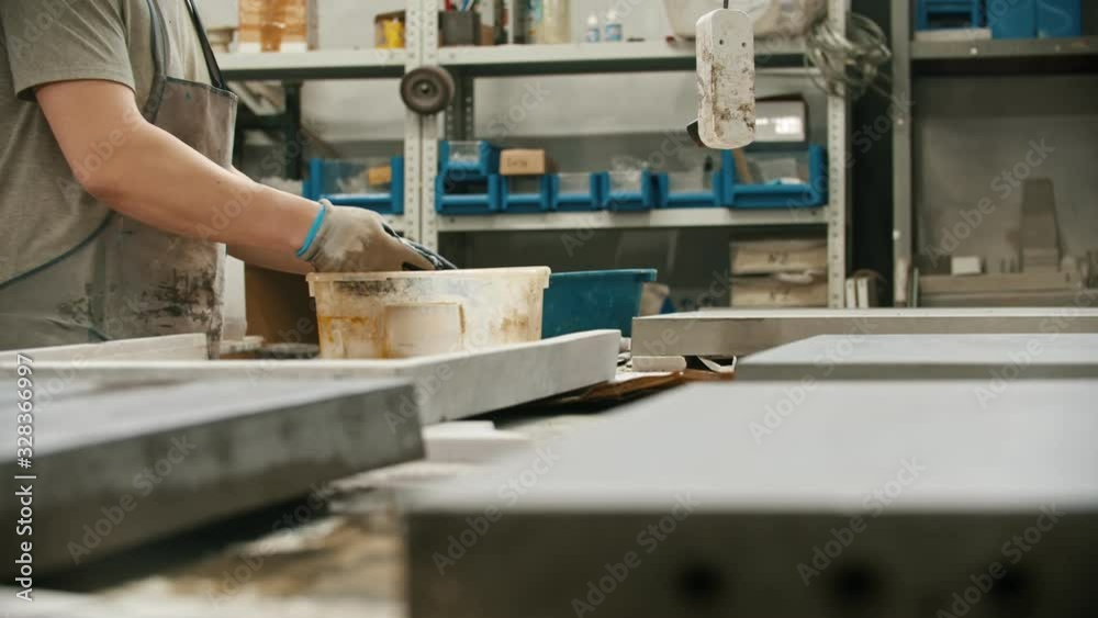 Working in the concrete industry - washing the concrete slab with water from the special capacity