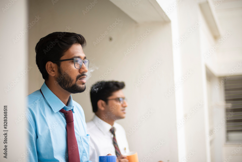 Corporate meetings with coffee/tea between young and energetic Indian Bengali bosses/officers/managers and secretary at balcony of the office building regarding a project. Indian corporate lifestyle Corporate meetings with coffee/tea between young and energetic Indian Bengali bosses/officers/managers and secretary at balcony of the office building regarding a project. Indian corporate lifestyle