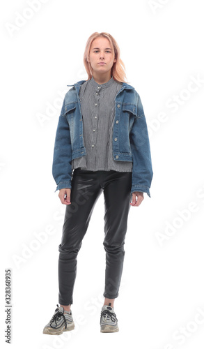 in full growth. serious stylish girl in a denim jacket