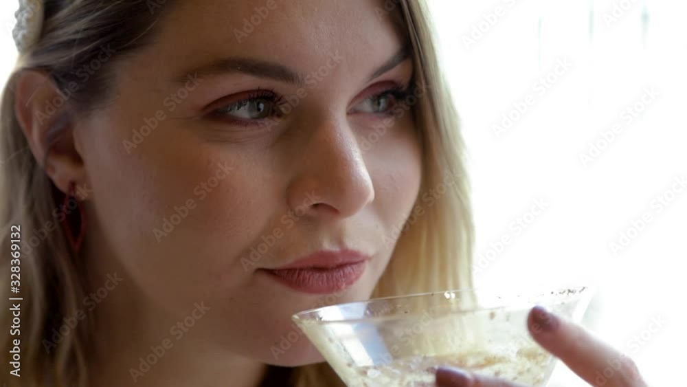 woman sitting in a cafe enjoying a chocolate coffee martini during mid day. she is happy drinking the alcoholic beverage in comfort while wearing fashionable elegant clothing woman sitting in a cafe enjoying a chocolate coffee martini during mid day. she is happy drinking the alcoholic beverage in comfort while wearing fashionable elegant clothing