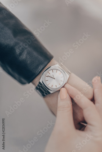 Silver stylish watch on woman hand