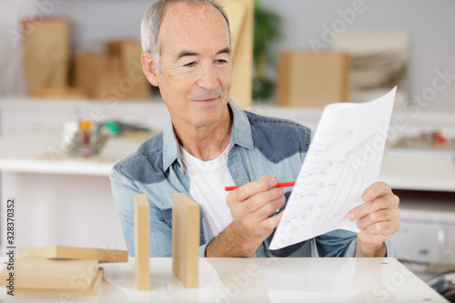 senior man reading instruction booklet