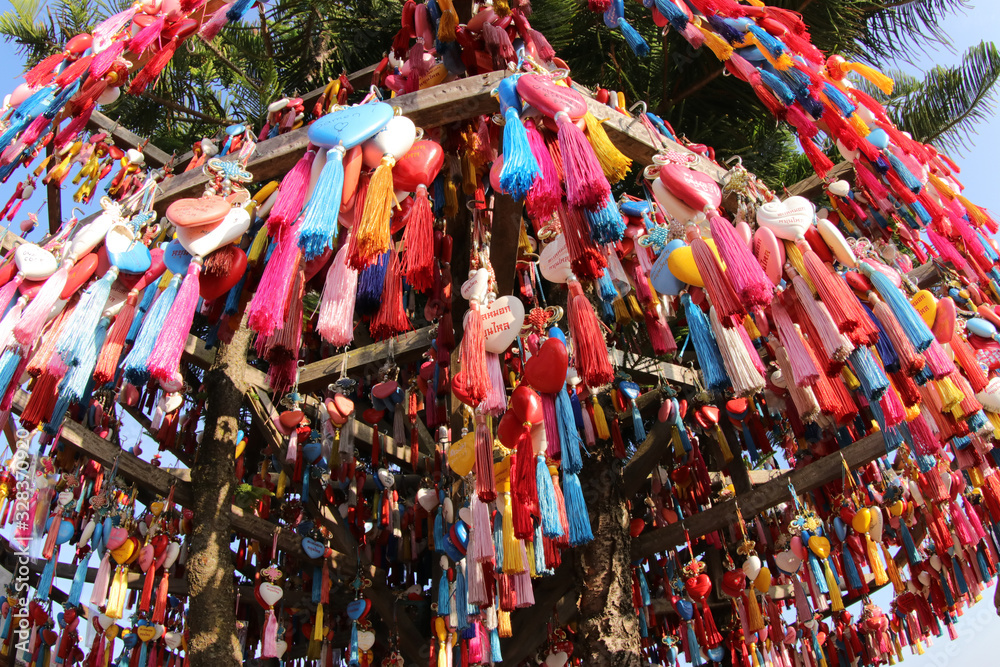 Mae Hong Son Province, Thailand - Jan 1, 2020: Colorful heart shaped key rings hanging around a tree as a souvenir to visit. Yon Lai Viewpoint