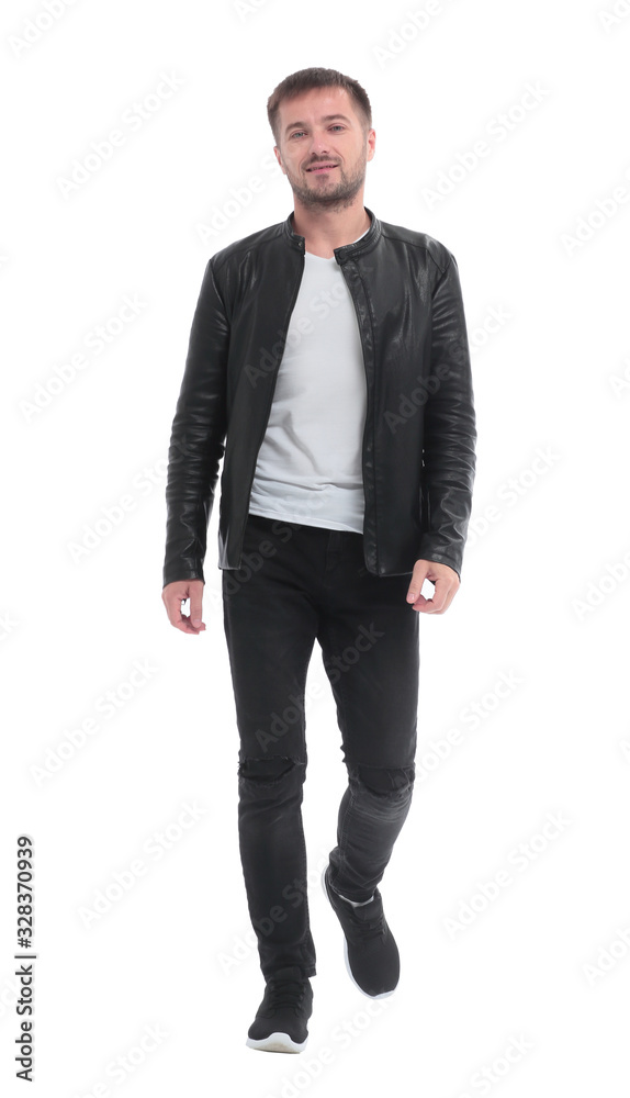 in full growth. casual young man walks forward . in full growth. casual young man walks forward .