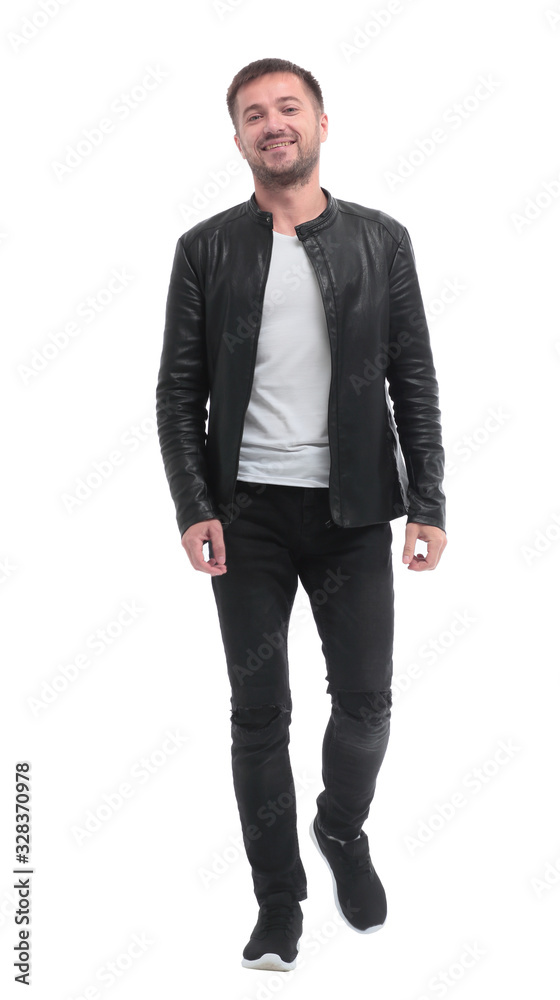 in full growth. casual young man walks forward . in full growth. casual young man walks forward .