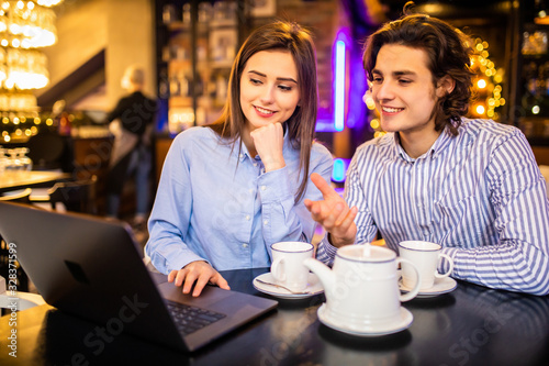 Young couple have fun while looking on laptop at cafe © F8  \ Suport Ukraine