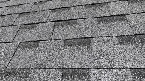 bitumen shingles of the round roof of the grey building close view