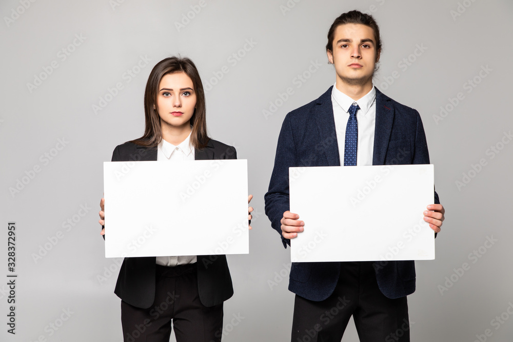 Confident business couple standing with blank board to advertise or invite isolated on white background Confident business couple standing with blank board to advertise or invite isolated on white background