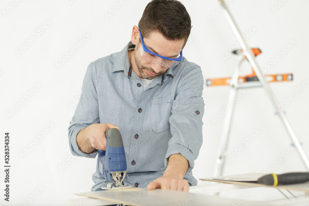 a man is wood sawing