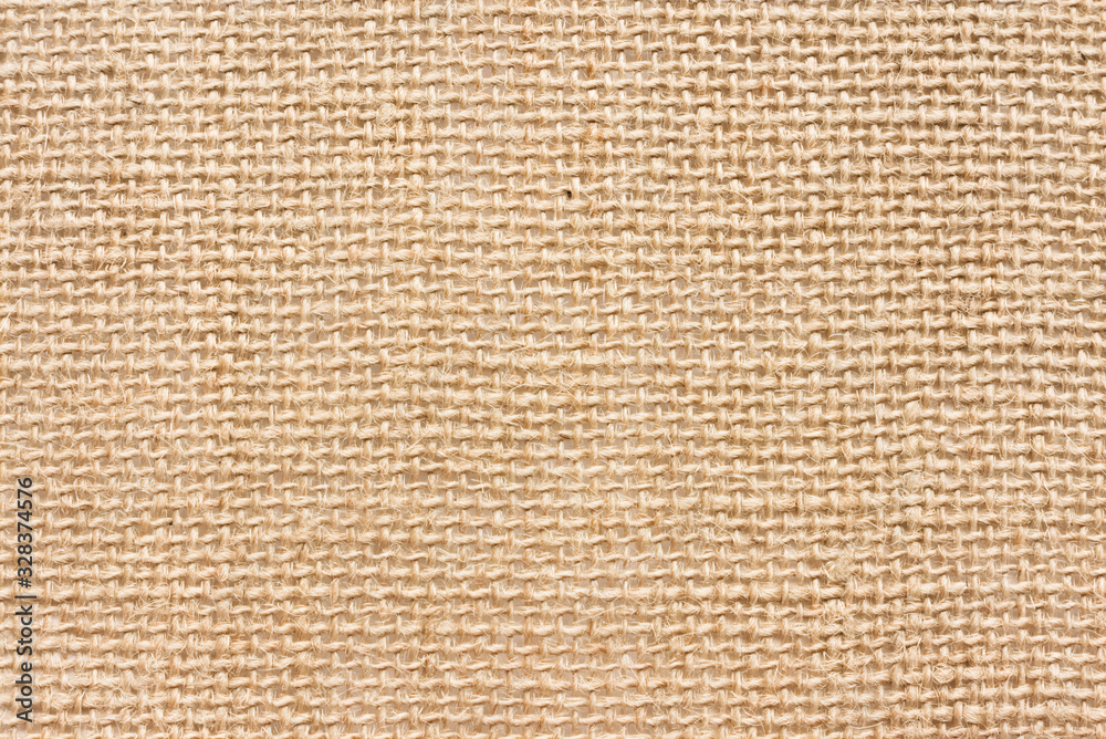 The texture of the rough linen fabric. Light rustic background. Natural material The texture of the rough linen fabric. Light rustic background. Natural material