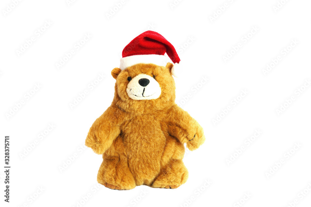 Children's toy teddy bear in the hat of Santa Claus. Isolate on a white background. Children's toy teddy bear in the hat of Santa Claus. Isolate on a white background.