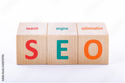 SEO concept. Search engine optimization text on wooden cubes on a white background.