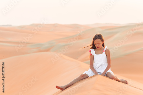 Girl among dunes in Rub al-Khali desert in United Arab Emirates