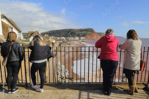 Group of tourists looking at the beach from the balcony in Sidmouth Devon
