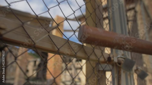 pull the baseball bat along the fence