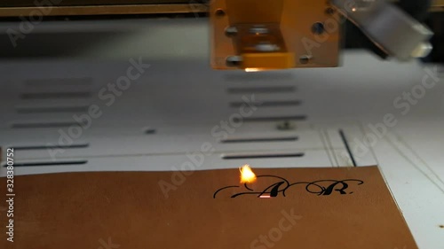 Laser engraving machine work,skin logo. Leather purse