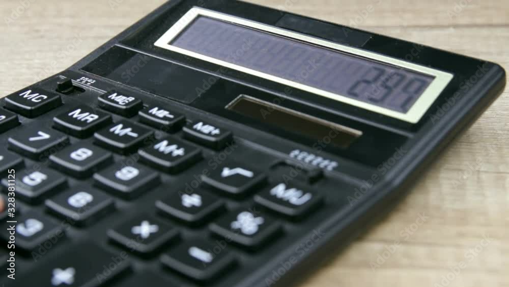Closeup of a business woman using calculator in office. Savings, finances and economy concept Closeup of a business woman using calculator in office. Savings, finances and economy concept