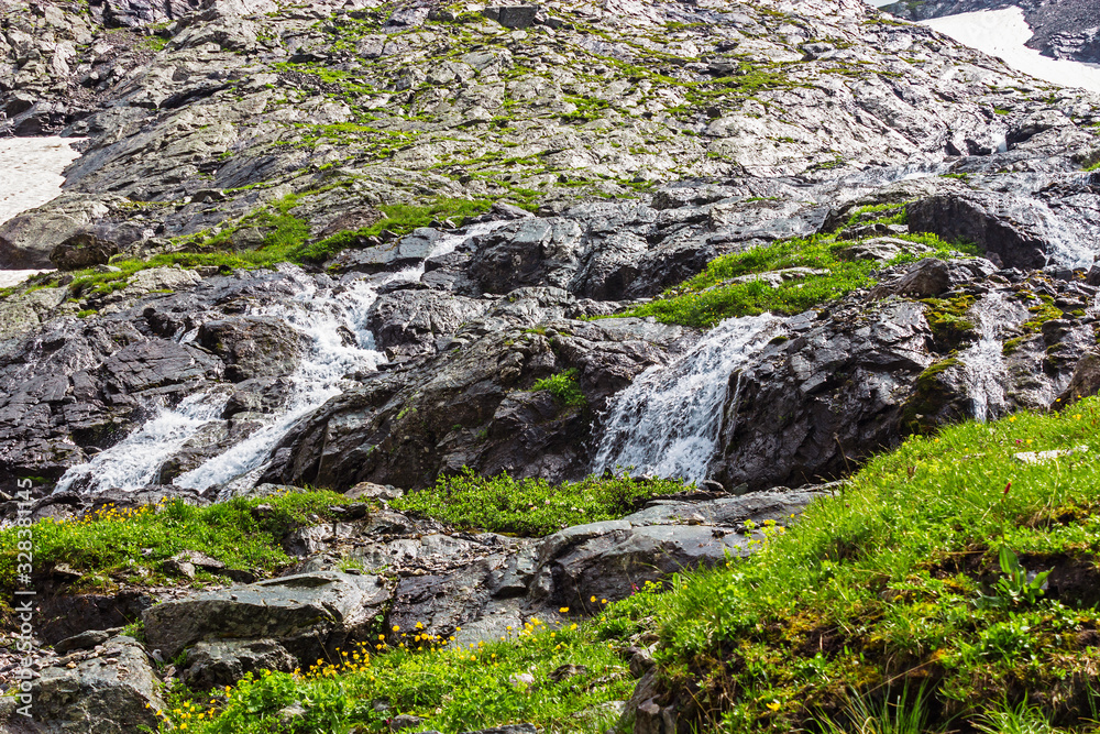fast mountain stream with a waterfall closeup fast mountain stream with a waterfall closeup