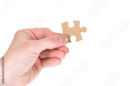 hand holding piece of puzzle