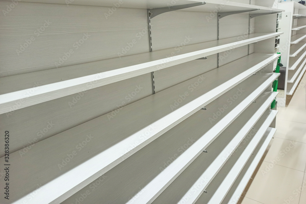 Empty supermarket shelves. Sale of goods. Black friday shopping sales concept. Concept: Excitement and panic, Epidemic and calamity. Empty supermarket shelves. Sale of goods. Black friday shopping sales concept. Concept: Excitement and panic, Epidemic and calamity.