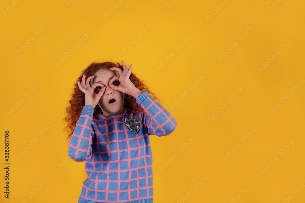 Beautiful red-haired girl on a yellow background Beautiful red-haired girl on a yellow background