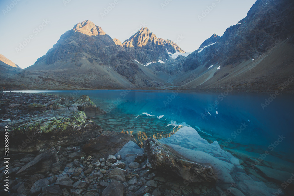 Beautiful wide view of Blavatnet - the norwegian glacial Blue Lake in Northern Norway, views of the Lyngen Alps