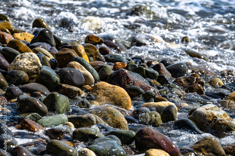 Pebbles on the sea beach. Background and texture. Travel and adventure. Pebbles on the sea beach. Background and texture. Travel and adventure.