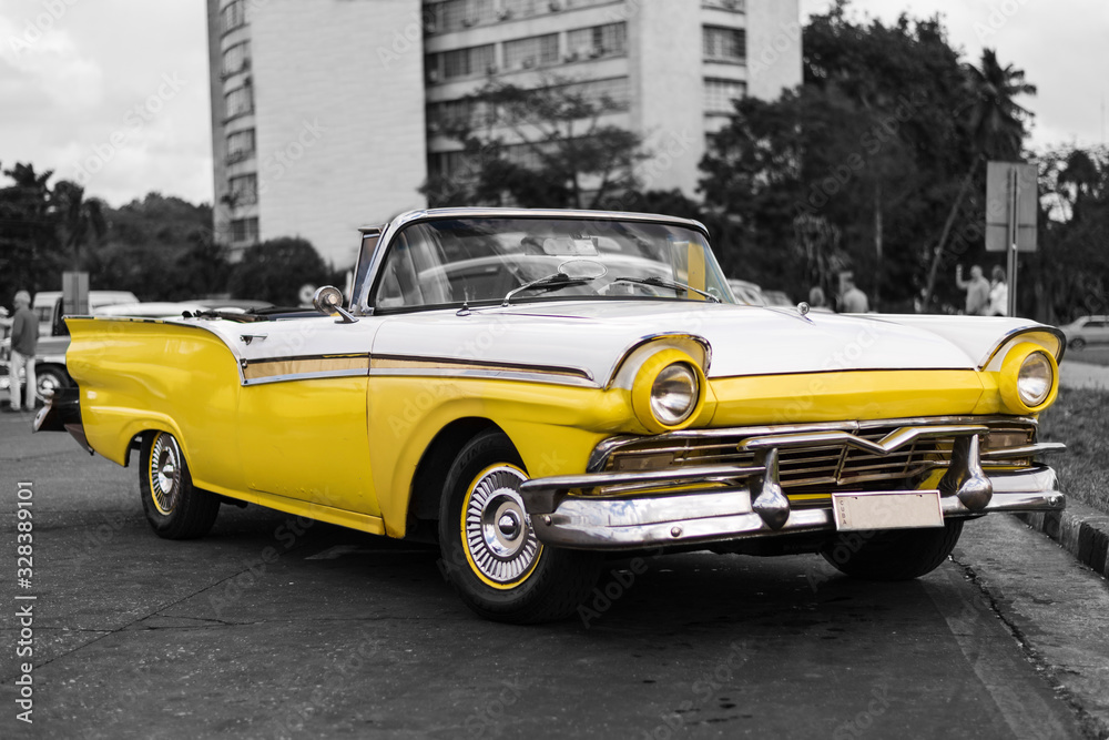 colorkey of yellow and white old american classic convertible car in havana cuba