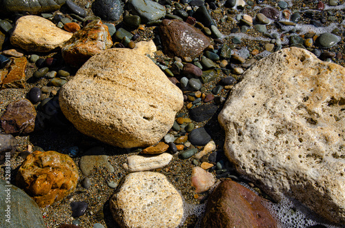 Pebbles on the sea beach. Background and texture. Travel and adventure.