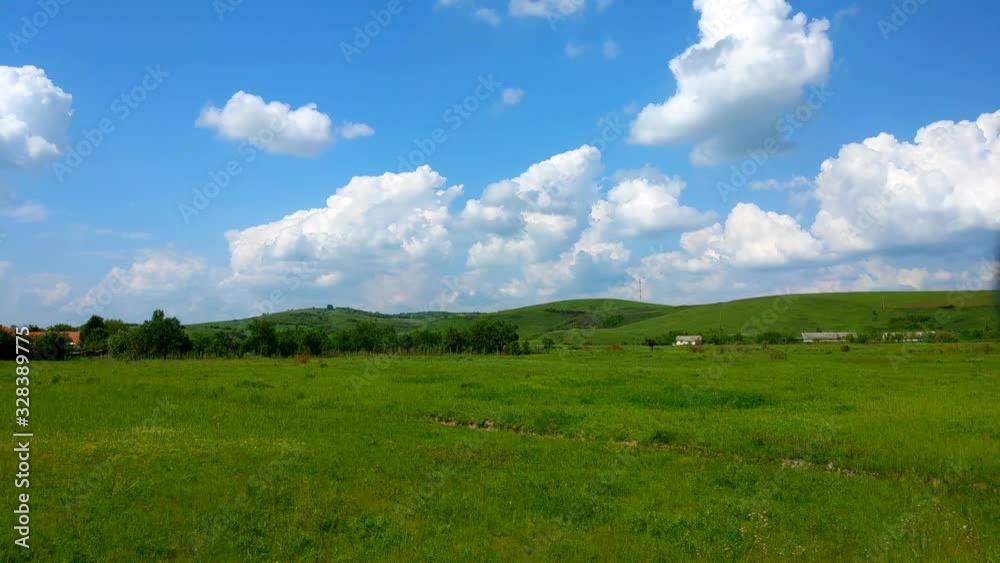 Landscape of green grass fields under blue sky with white clouds, time-lapse movement, nature and relax, climate change concept. Landscape of green grass fields under blue sky with white clouds, time-lapse movement, nature and relax, climate change concept.