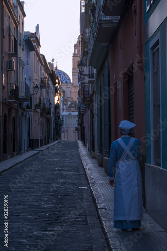 Nurse of the year 1890 walking on the street.