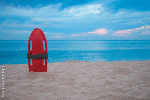 Isolated Lifeguard rescue can at the shore with the ocean as background