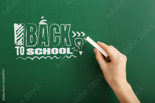 Woman writing phrase BACK T...