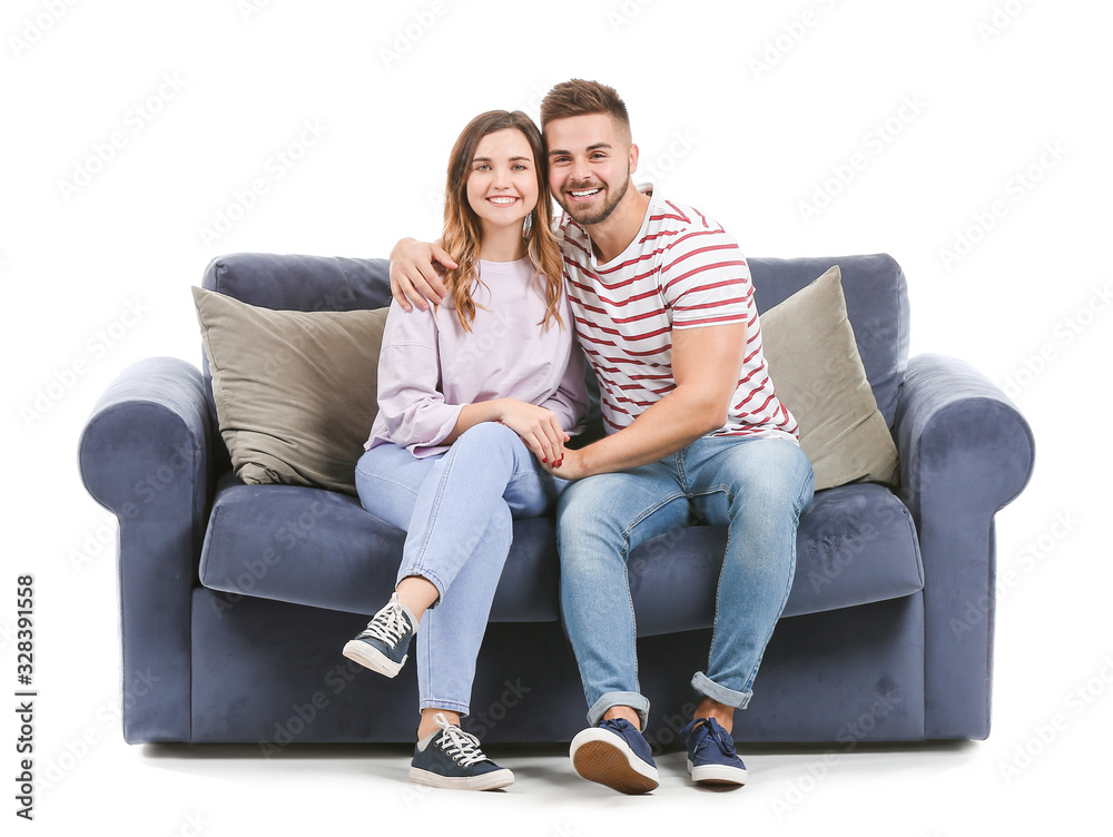 Young couple sitting on sofa against white background