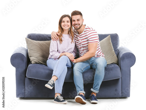 Young couple sitting on sofa against white background