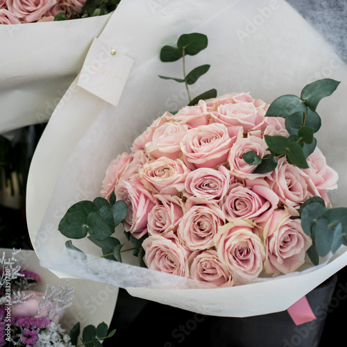 A variety of colors near the Liberty store in London. Large bouquets in tin vases. Pink roses photo