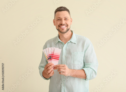 Man with color palettes on light background