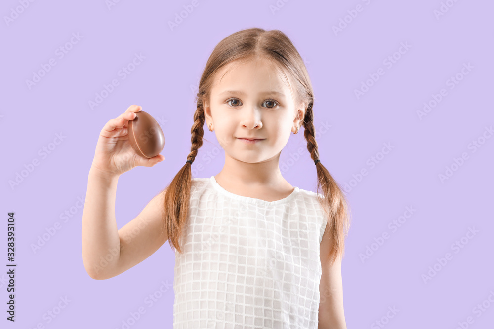 Cute little girl with sweet chocolate egg on color background Cute little girl with sweet chocolate egg on color background