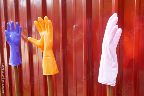 Colorful rubber hand gloves with red background