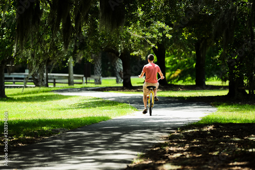 Young man riding a  bike on path in HILTON HEAD ISLAND SC. 