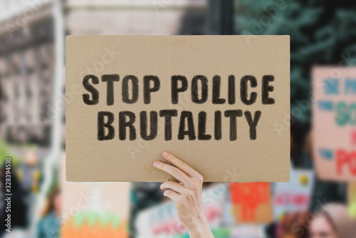 Canvas Print The phrase  Stop police brutality  on a banner in men's hand
