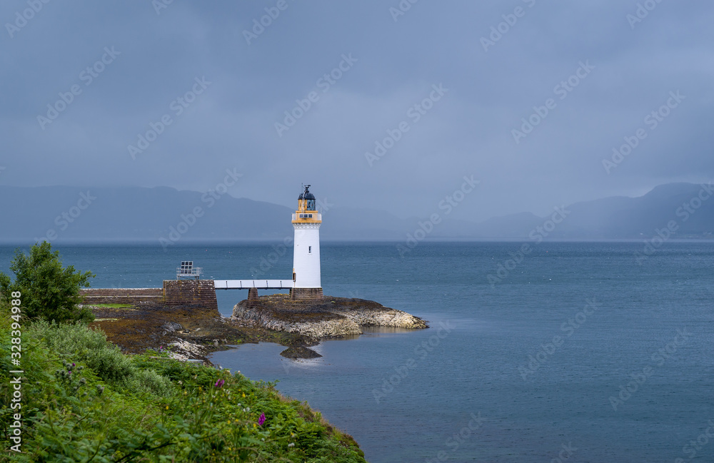 Nothern sea at cloudy weather and Tobermory Lighthouse. Island of Mull, Scotland